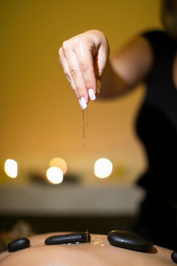 Alia Palace Hotel - Adults Only 16+ Chalkidike Exteriör bild A woman dripping oil on her hands