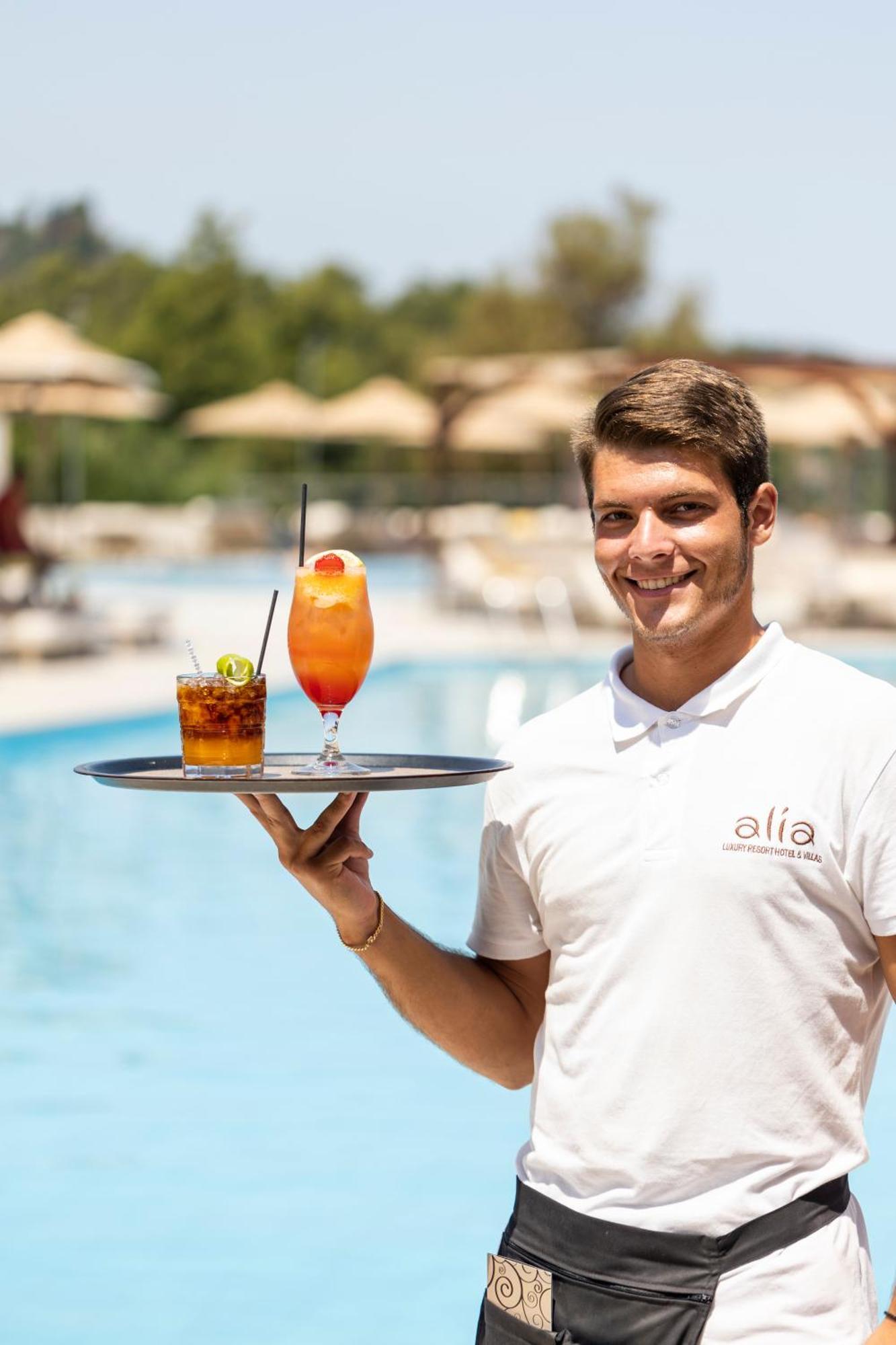 Alia Palace Hotel - Adults Only 16+ Chalkidike Exteriör bild A waiter serving drinks